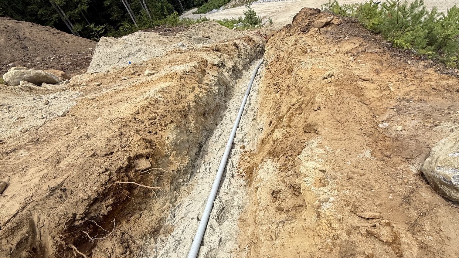 Underground service conduit run before backfill